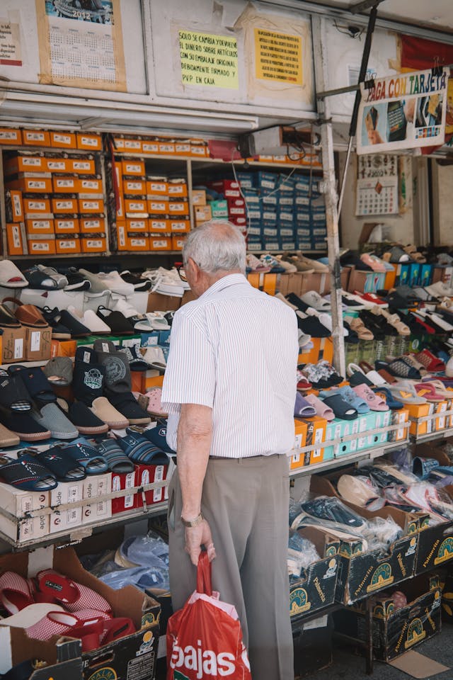 elderly man browsing a local market