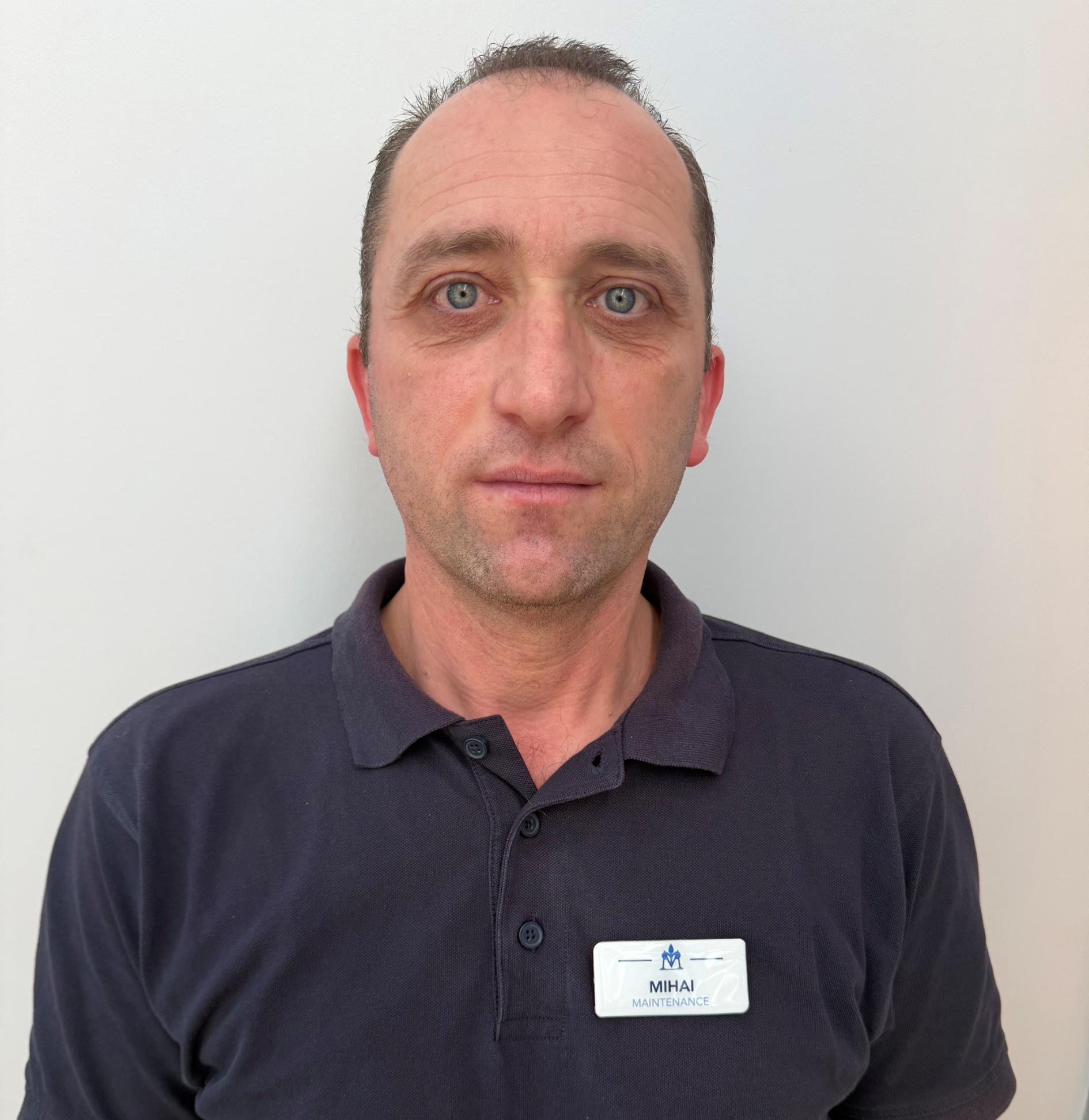 maintenance worker in black polo shirt