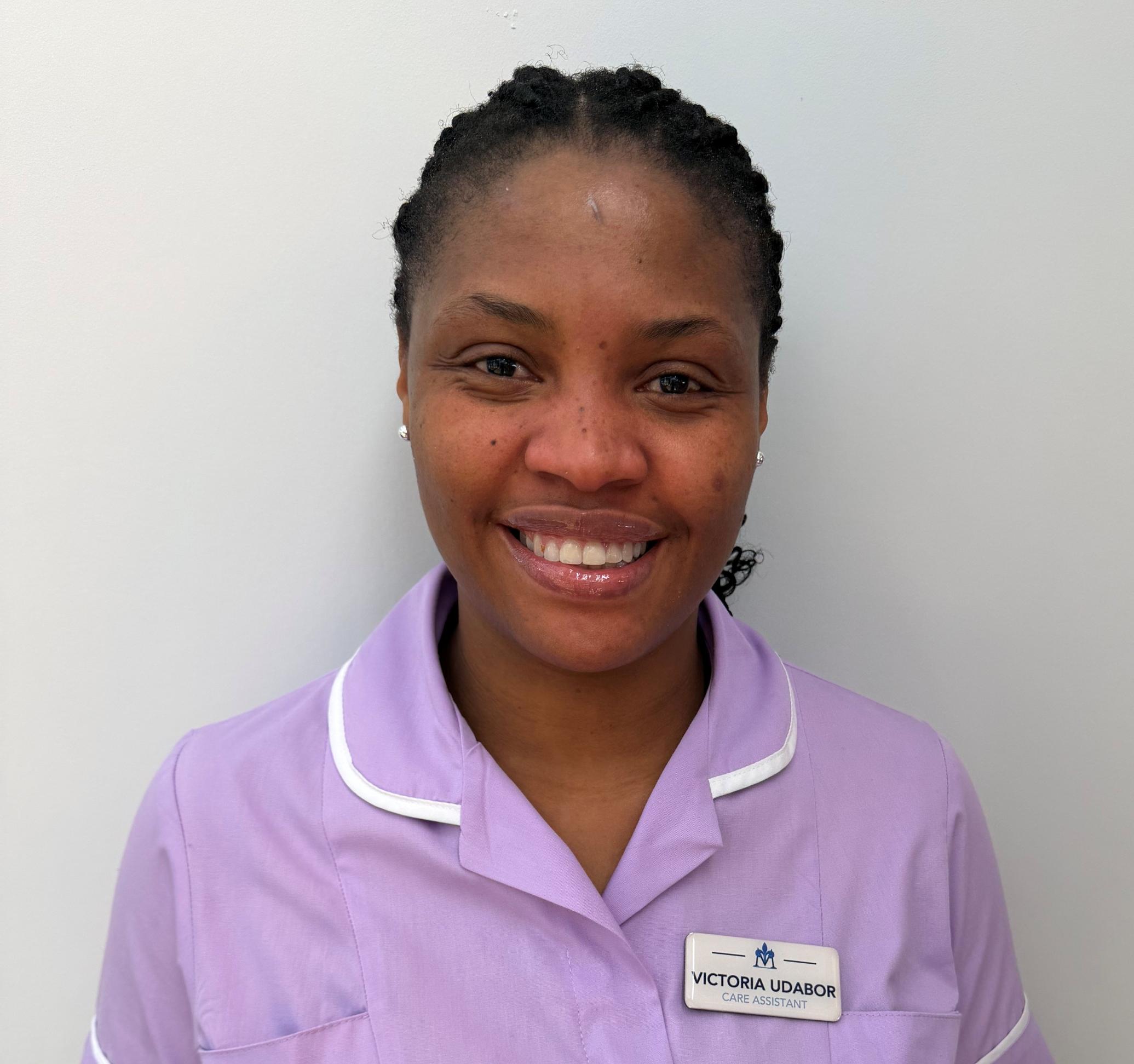 Smiling woman in lavender nurses uniform