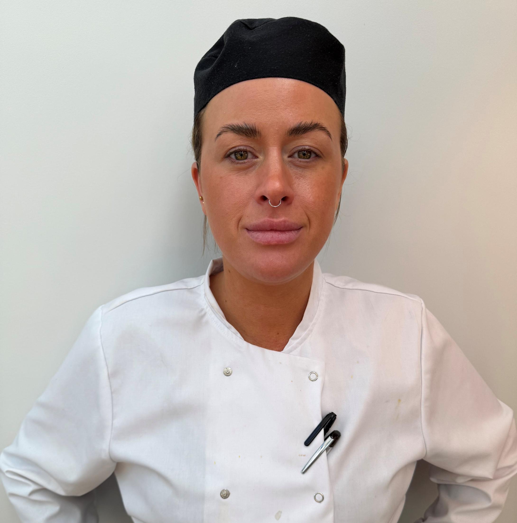 Woman in chef uniform and hat