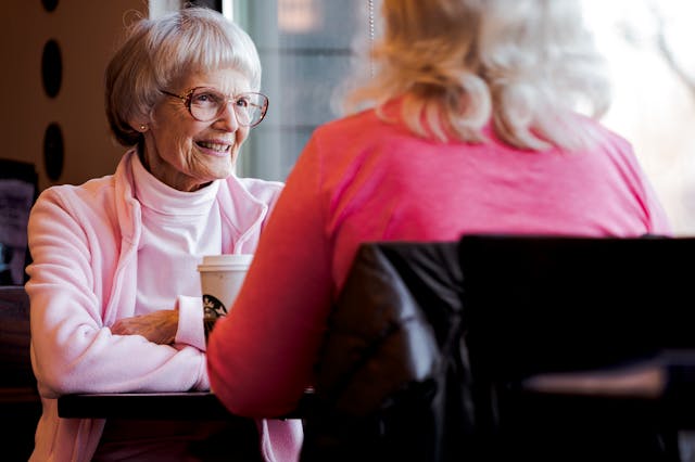 elderly woman smiling in cafe