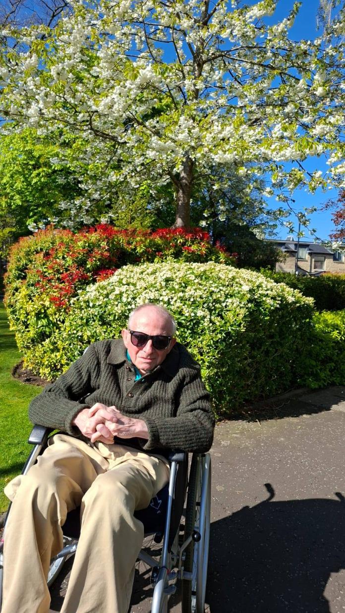 man in wheelchair in sunny garden