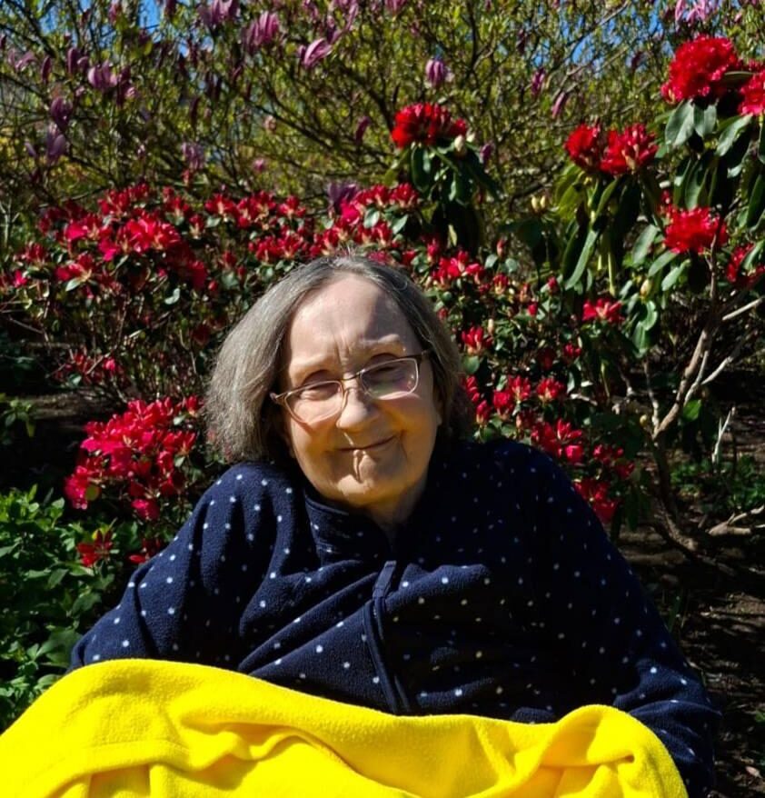 elderly woman smiling in the garden