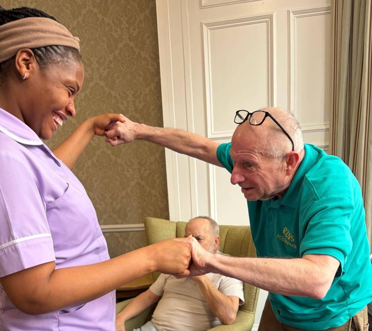 resident dancing with staff member