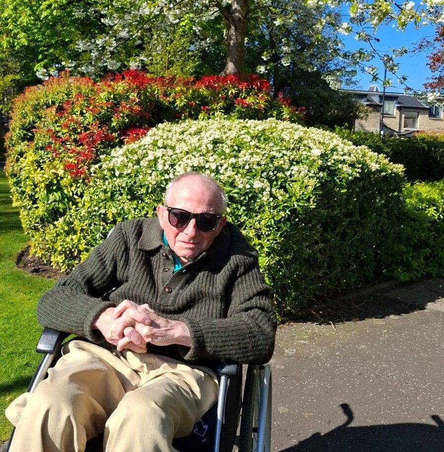older man in a wheelchair outside