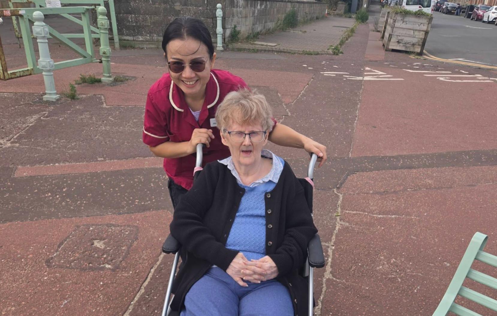 residents in wheelchair with carer